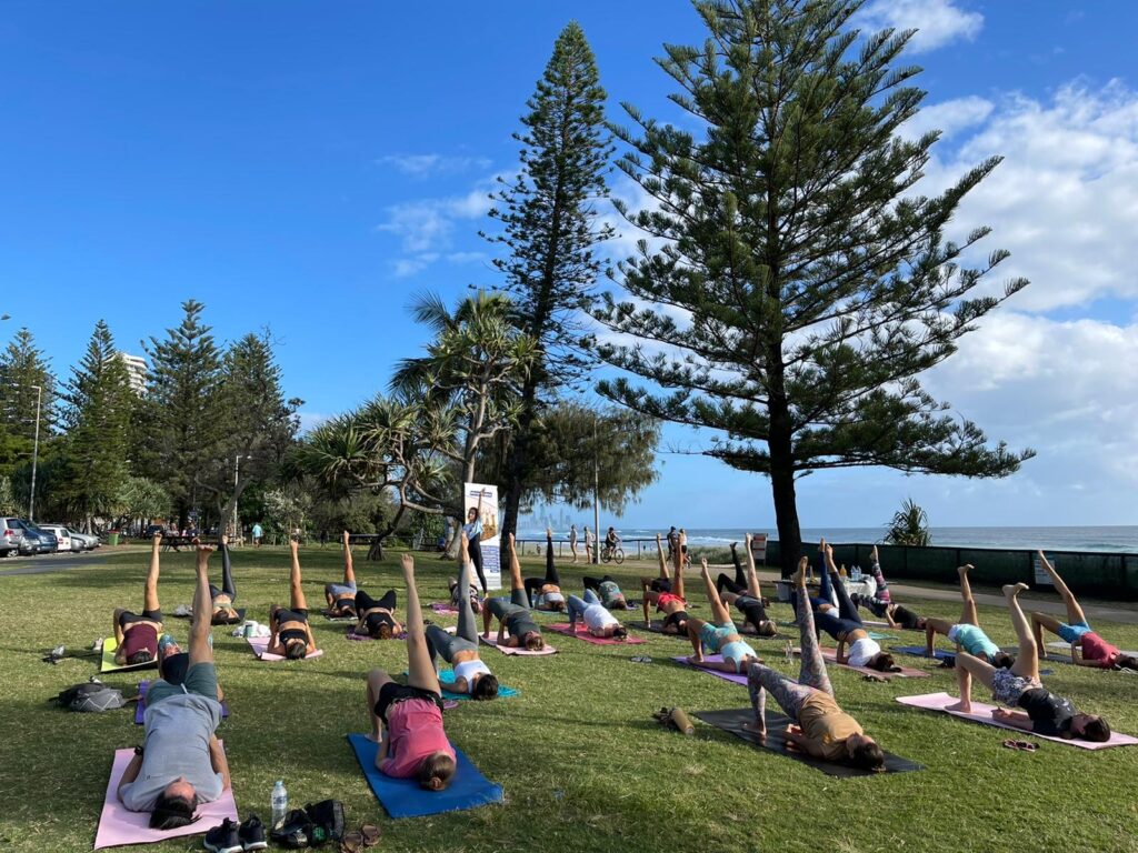 International-students-smiling-doing-a-yoga-class-on-the-beach.